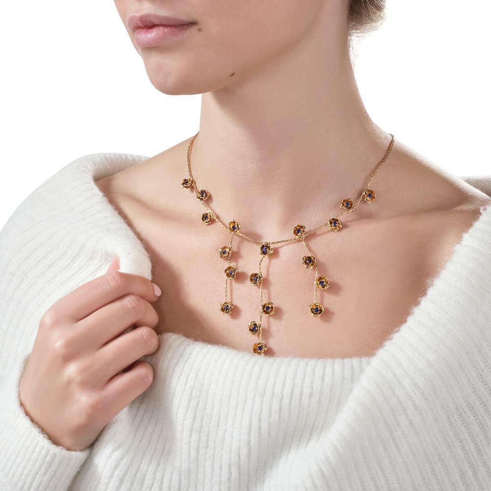 Lifestyle jewellery photograph showing strong contrast and gloss on metallic surfaces