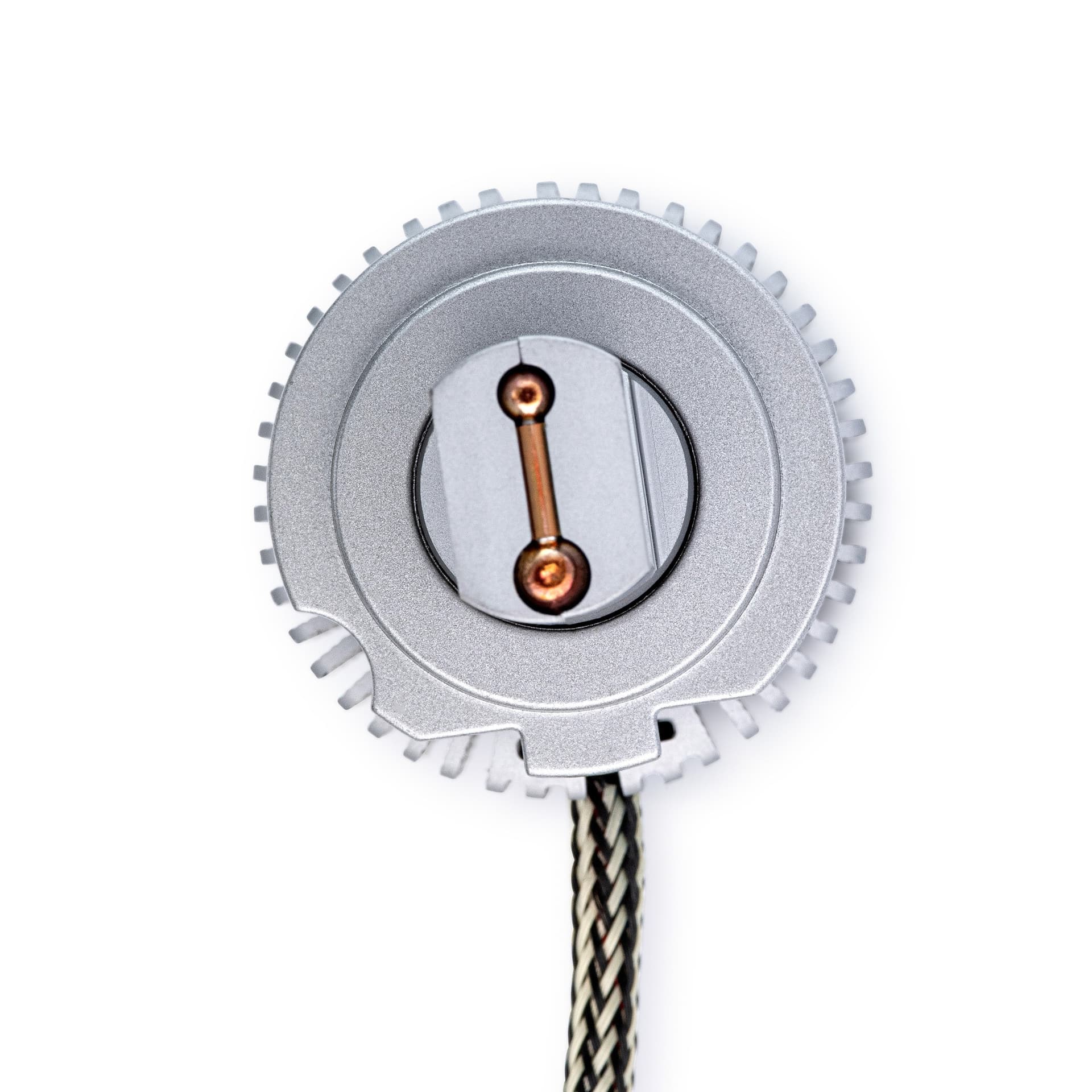 Rear view of a round silver light component showing contacts and a braided cable
