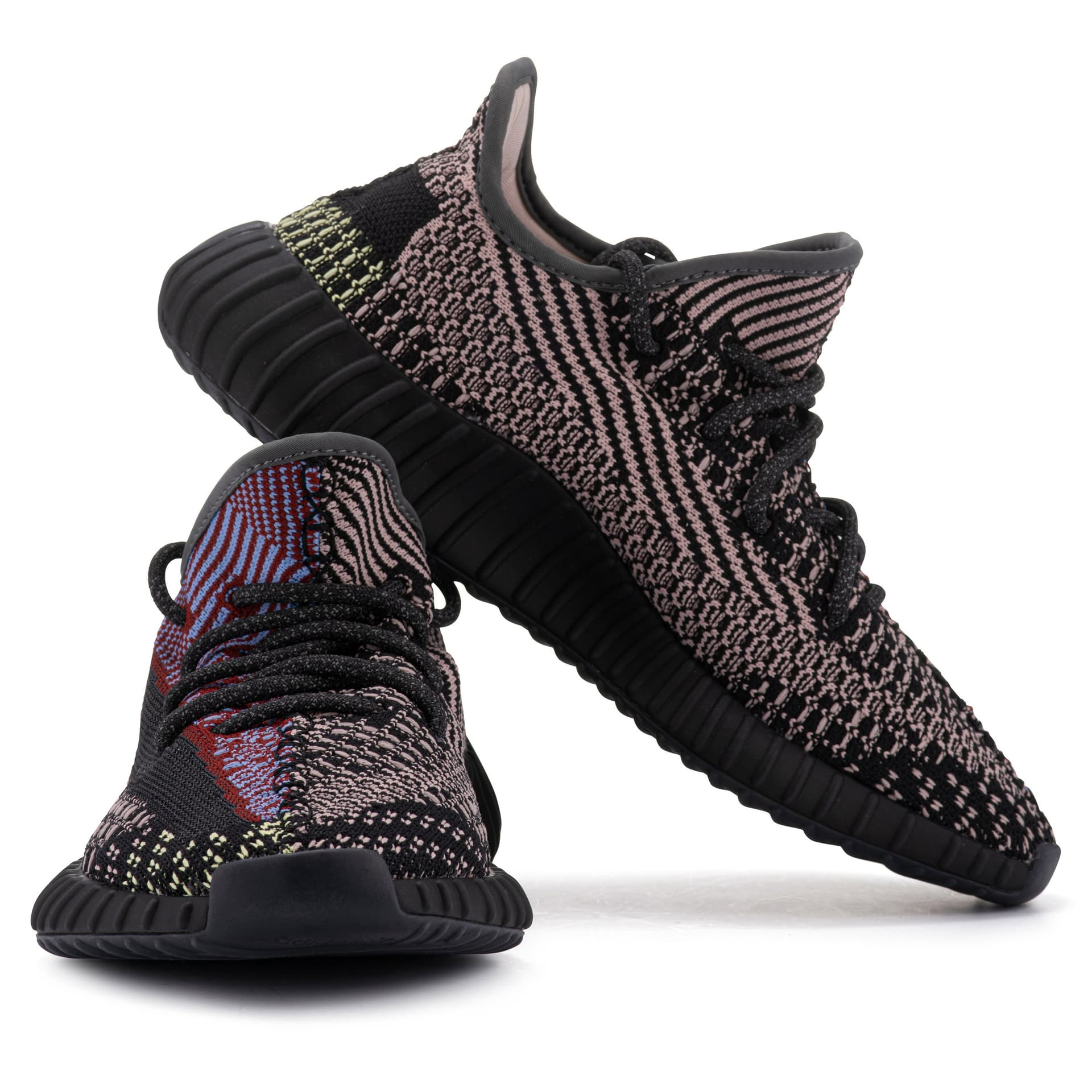 Knitted trainers arranged to show the front, side and shape of the sole